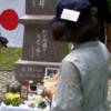 JAPANESE LADY LOOKING AT A PHOTO OF HER FATHER WHO WAS KILLED ON GUADALCANAL.